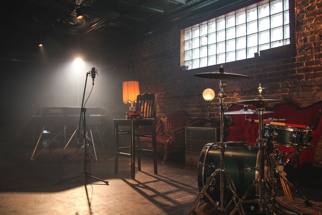 Music video production filming with dramatic stage lighting and artist on set
